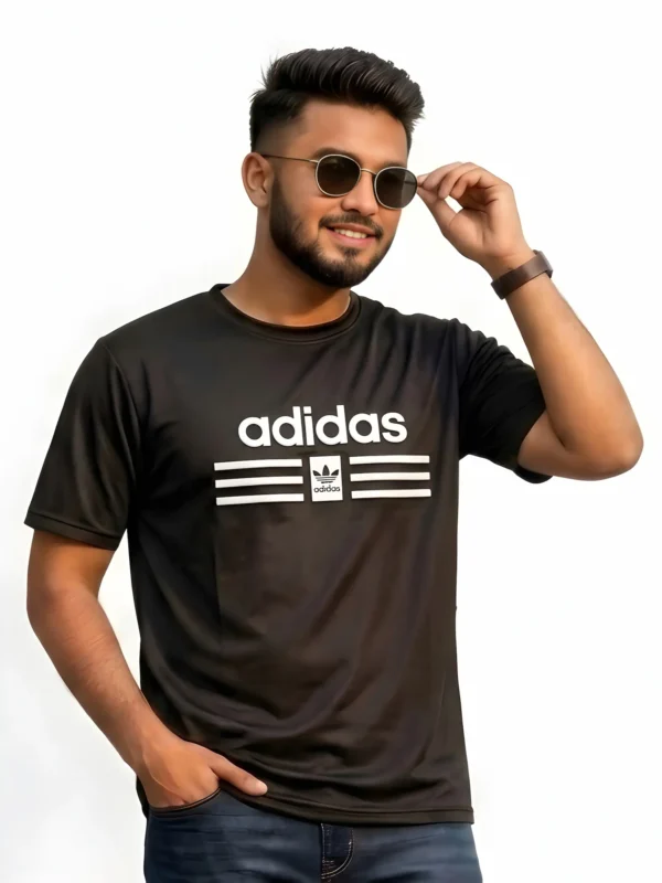 Close up of man wearing an Adidas men's black mesh t-shirt with a raised 3D pumped print logo