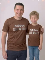 Smiling father and son wearing matching Adidas brown mesh t-shirts with 3D pumped print logos