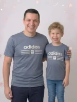 Smiling father and son wearing matching Adidas brown mesh t-shirts with 3D pumped print logos