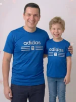 Smiling father and son wearing matching Adidas brown mesh t-shirts with 3D pumped print logos