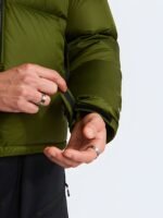 Close-up of the adjustable Velcro wrist cuffs on an olive green puffer jacket.