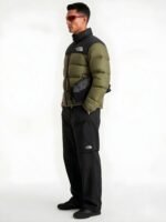 Side profile view of a model showcasing the fit of a men's olive green puffer jacket.