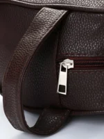 Navy blue, brown, and black leather travel dopp kits flatlay