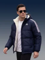 Man walking outdoors in a thick winter sherpa lined puffer jacket.