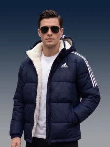 Man wearing navy blue Adidas inspired sherpa jacket with sunglasses.