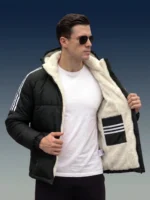 Man opening his black puffer jacket to reveal a thick white sherpa inner lining.