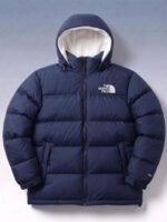 Front view of the TNF-inspired Navy Sherpa Puffer Jacket 700 showing the thick baffling and bright white sherpa-lined hood.