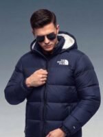 Male model wearing the zipped-up navy sherpa puffer jacket 700 with sunglasses, demonstrating the winter streetwear fit.