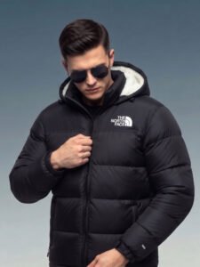 Black Sherpa Puffer Jacket Male model adjusting the collar of the fully zipped black puffer jacket 700, demonstrating its protective fit against harsh winter weather.
