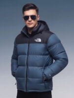 Model wearing blue puffer jacket, front view looking away