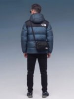 Back view of model wearing blue The North Face puffer jacket