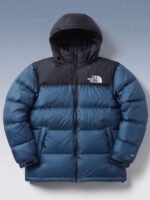 Close up of model adjusting zipper on blue puffer jacket