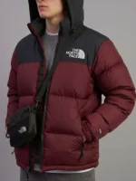 Close up detail of the men's 700-down winter coat showing the maroon and black two-tone design.