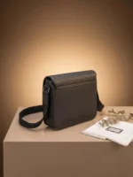 Back view of a designer-inspired messenger bag highlighting a scratch-resistant textured panel.